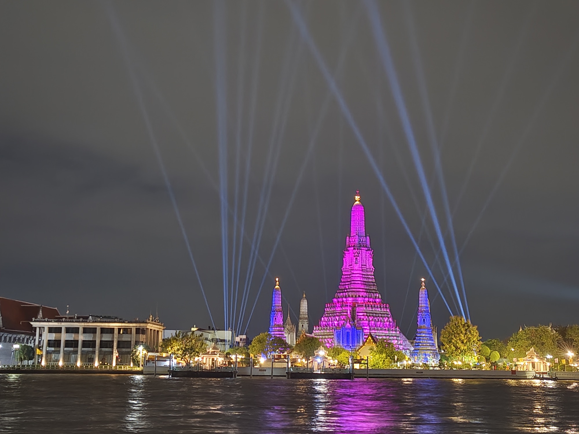 Wat Arun lit up at night across the Chao Phraya river