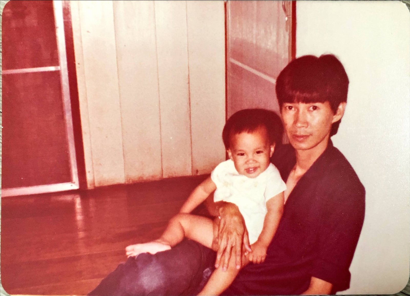 The author with his father, 1982, on the timber floor of the family shophouse in the old town. Four of us and the woman who raised me lived three floors above the shop until the early 1980s, when the arithmetic said suburbs.